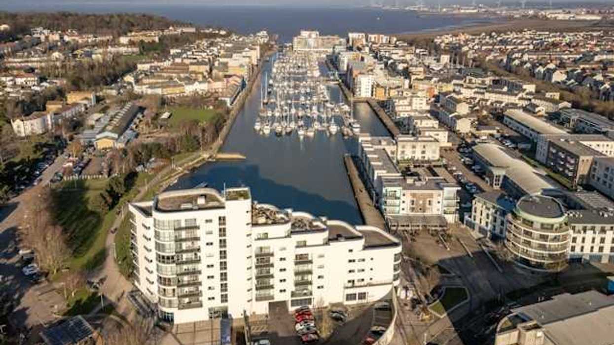 Aerial view of city buildings and boats on water
