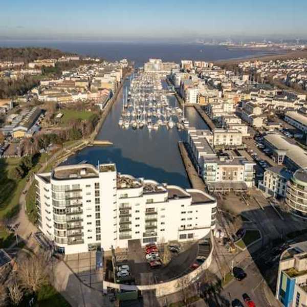 Aerial view of city buildings and boats on water