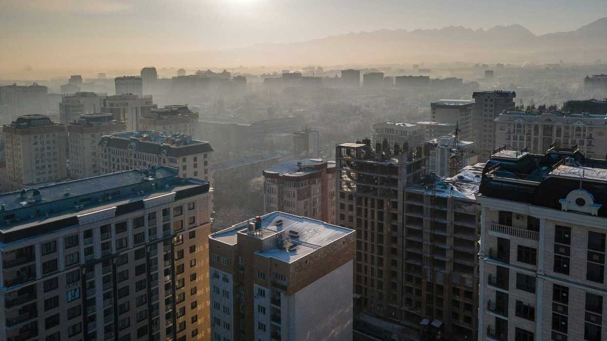 aerial view of city buildings with smog during daytime.