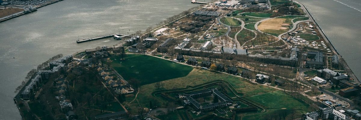 aerial view of Governors Island, New York Harbor on a partly cloudy day.