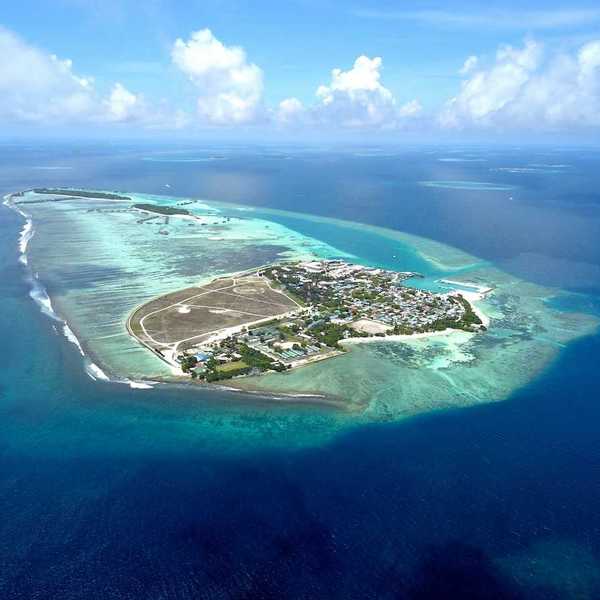 Aerial view of Himmafushi island in the Maldives exemplifying sea level vulnerability