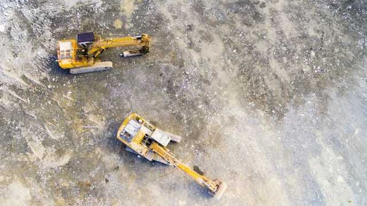 Aerial view of mining equipment on bare grey earth