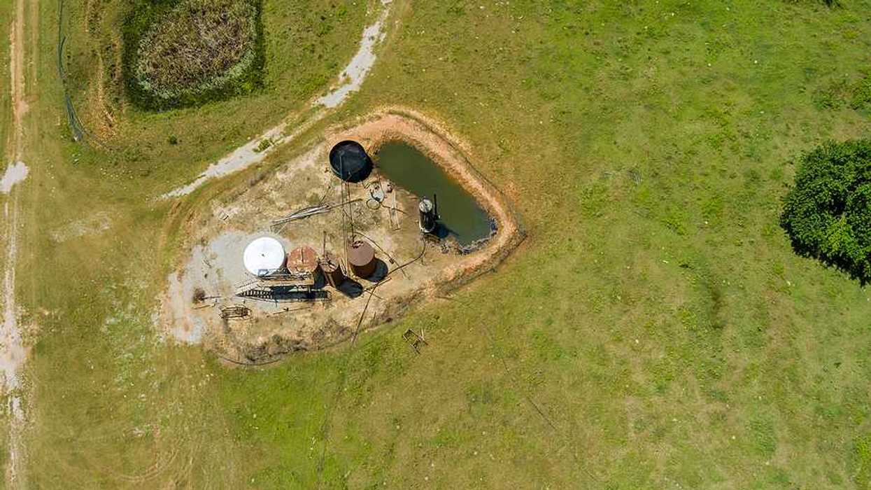 Aerial view of oil well pump jack in Oklahoma on a sunny day
