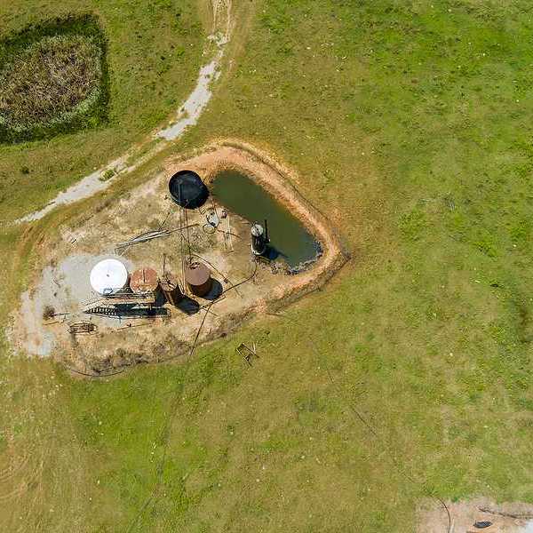 Aerial view of oil well pump jack in Oklahoma on a sunny day