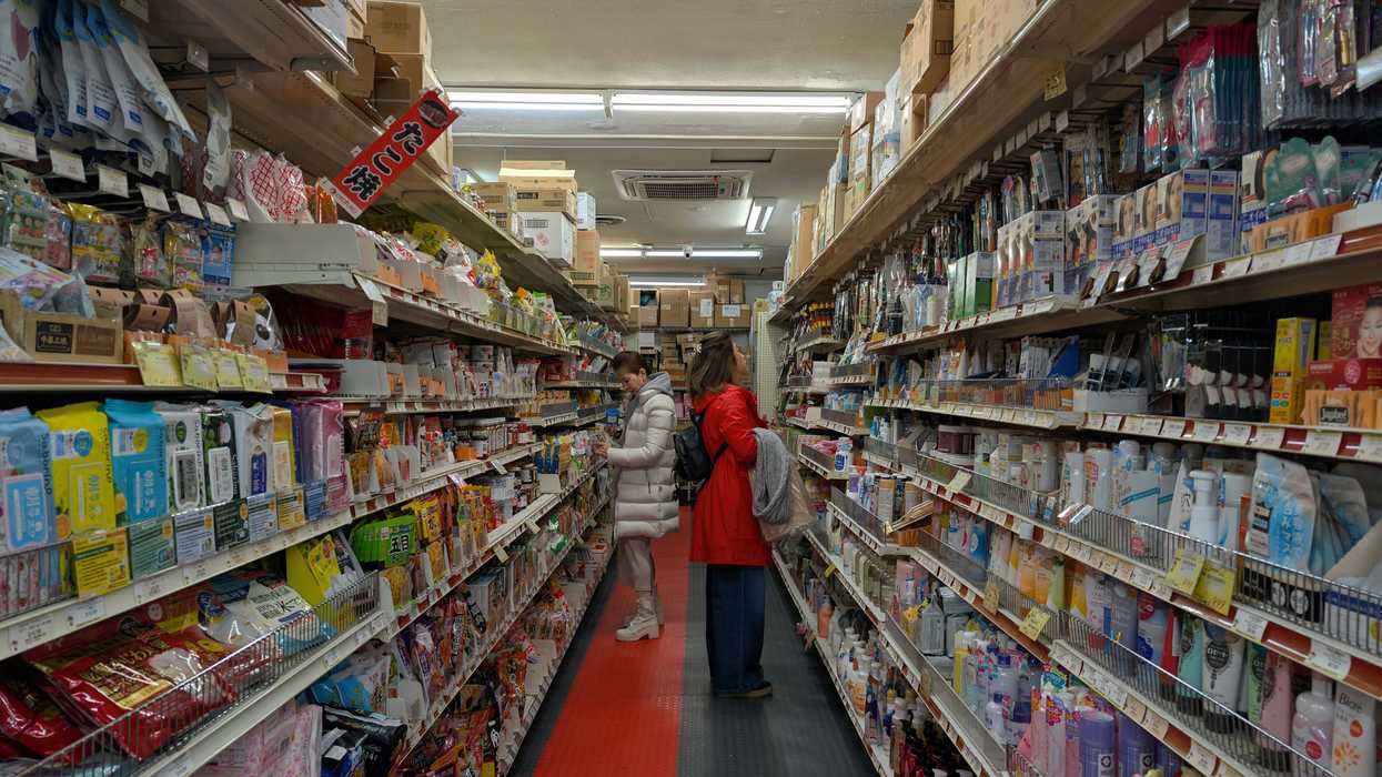 Aisle of a well-stocked retail store with many products.