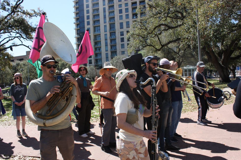 Alexis Ramírez, Corpus Christi resident and elementary music teacher, plays her bass clarinet alongside band while marching during the protest.