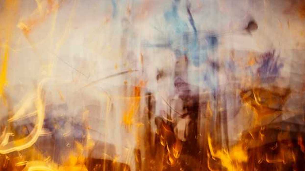 An abstract view of flames with smoke rising from them