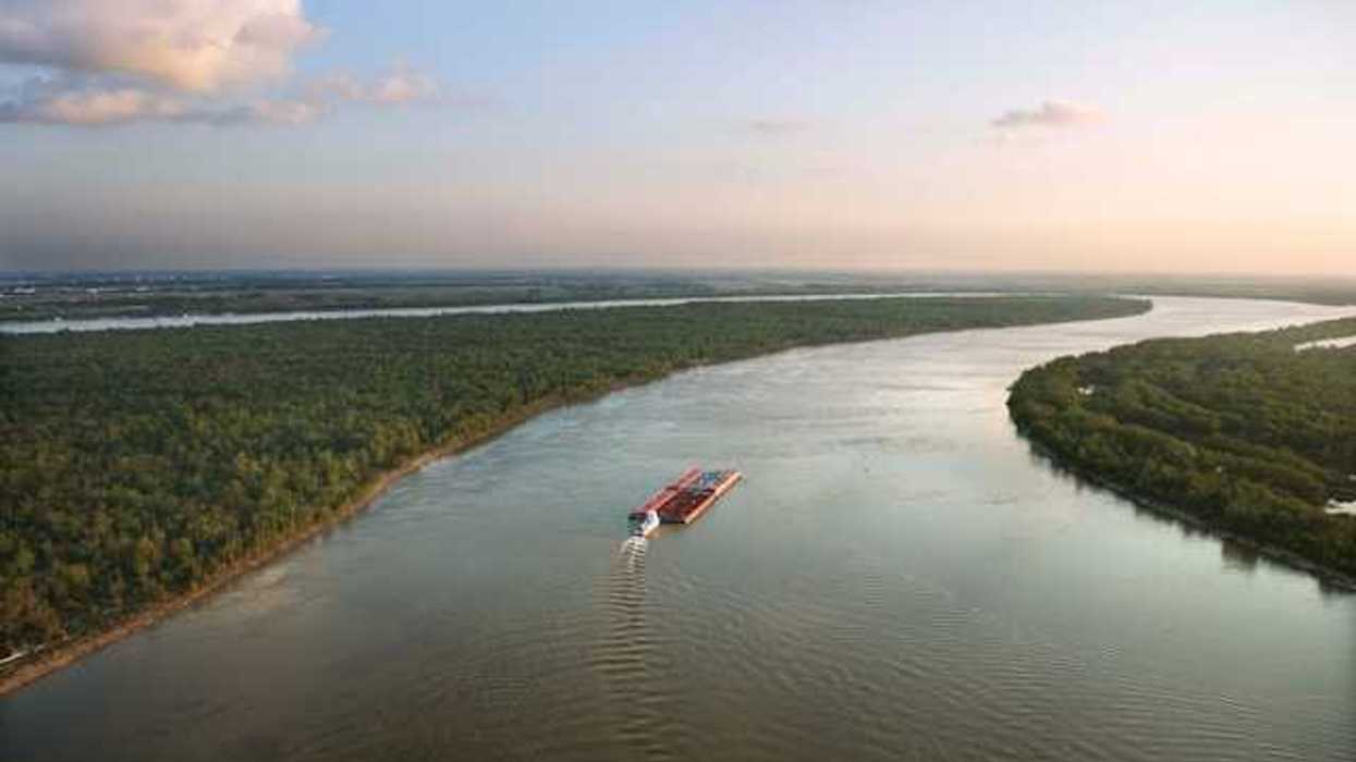 An aerial view of a barge traveling down the Mississippi River