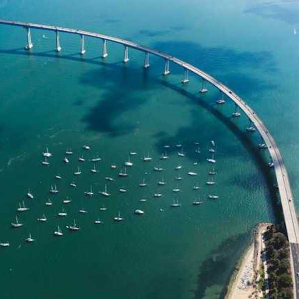 An aerial view of a body of water with a bridge crossing it