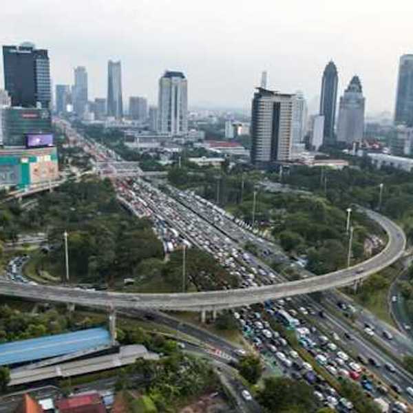 An aerial view of a city with a busy freeway cutting through it