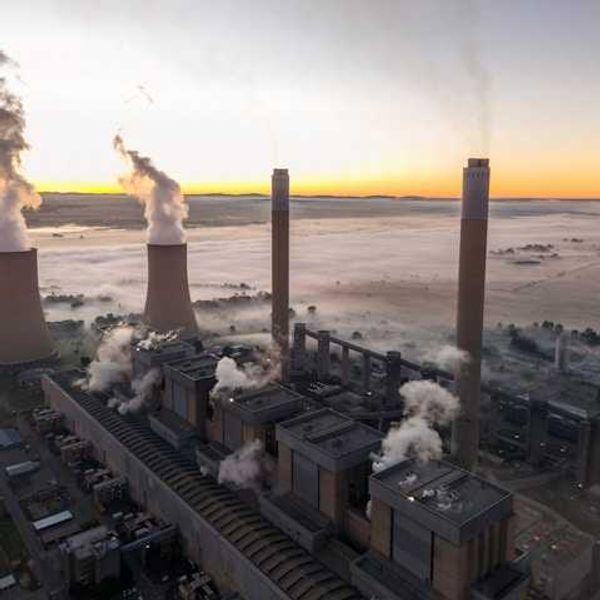 An aerial view of a coal plant surrounded by fog