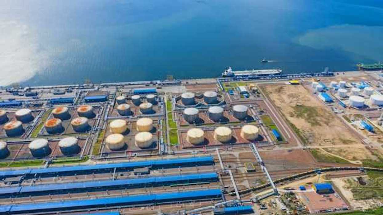 An aerial view of a desalination plant on the edge of a water source