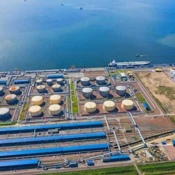 An aerial view of a desalination plant on the edge of a water source
