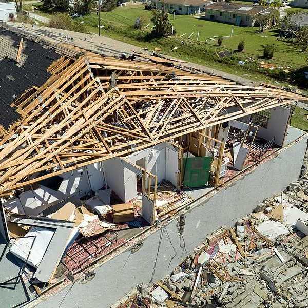 An aerial view of a home that has been damaged by a hurricane