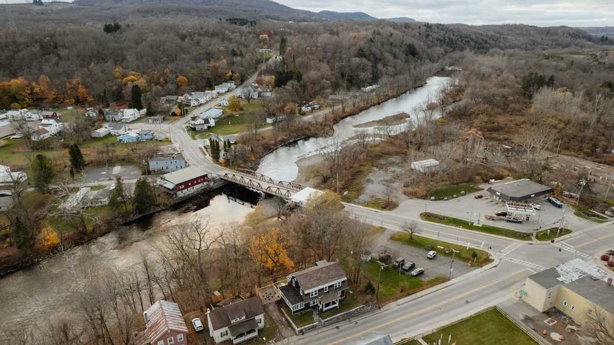 An aerial view of a new england town bisected by a river
