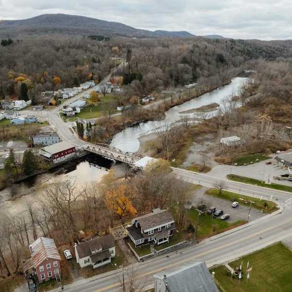 An aerial view of a new england town bisected by a river