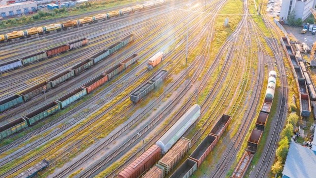 An aerial view of a rail yard with tracks and trains