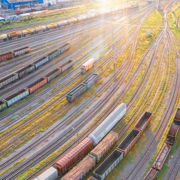 An aerial view of a rail yard with tracks and trains