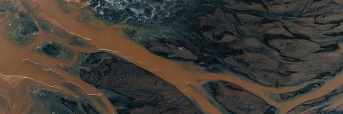 An aerial view of a river system with brown water.