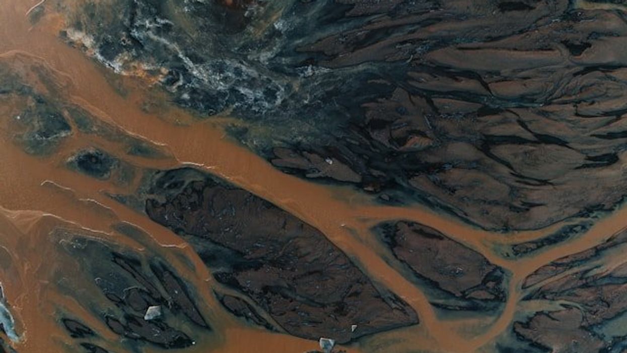 An aerial view of a river system with brown water.