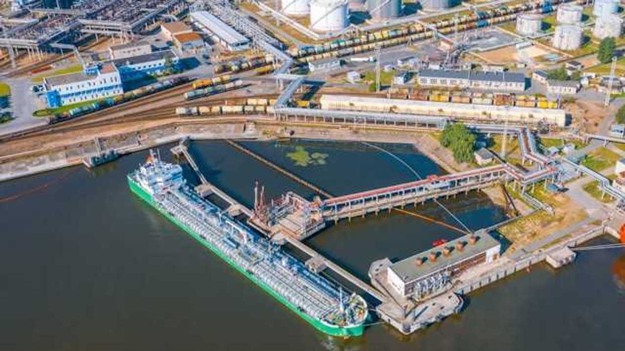 An aerial view of a ship docked at an oil refinery