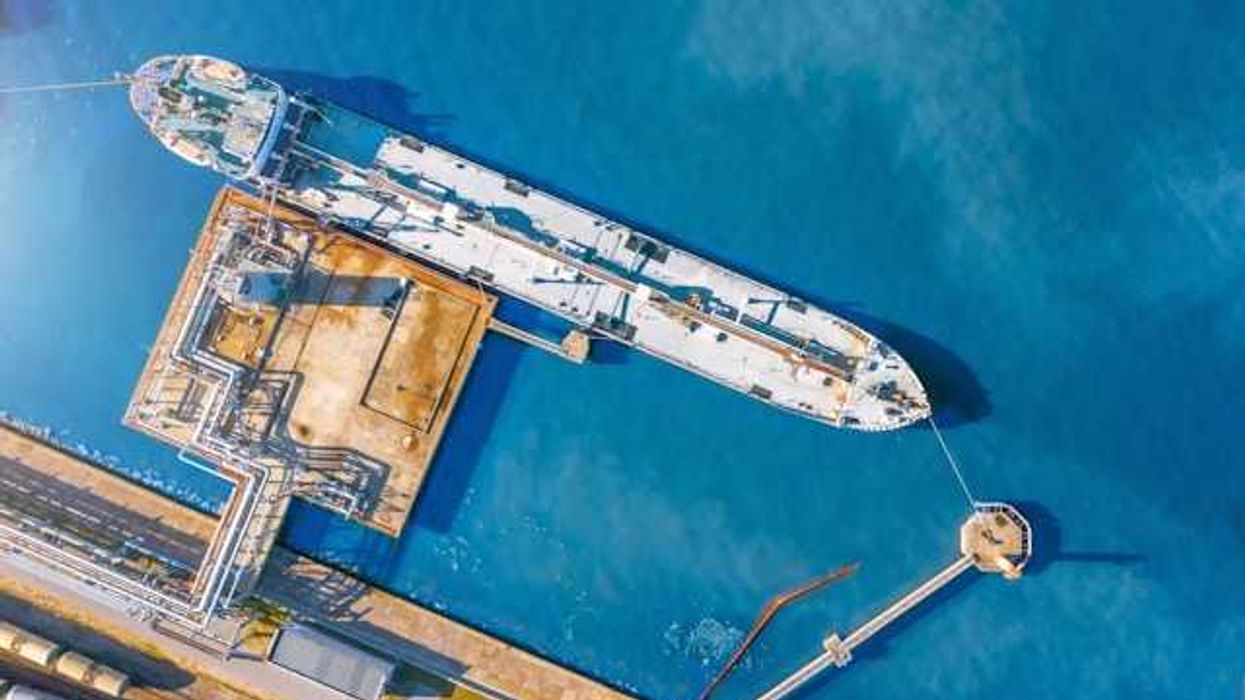 An aerial view of a tanker ship at a dock