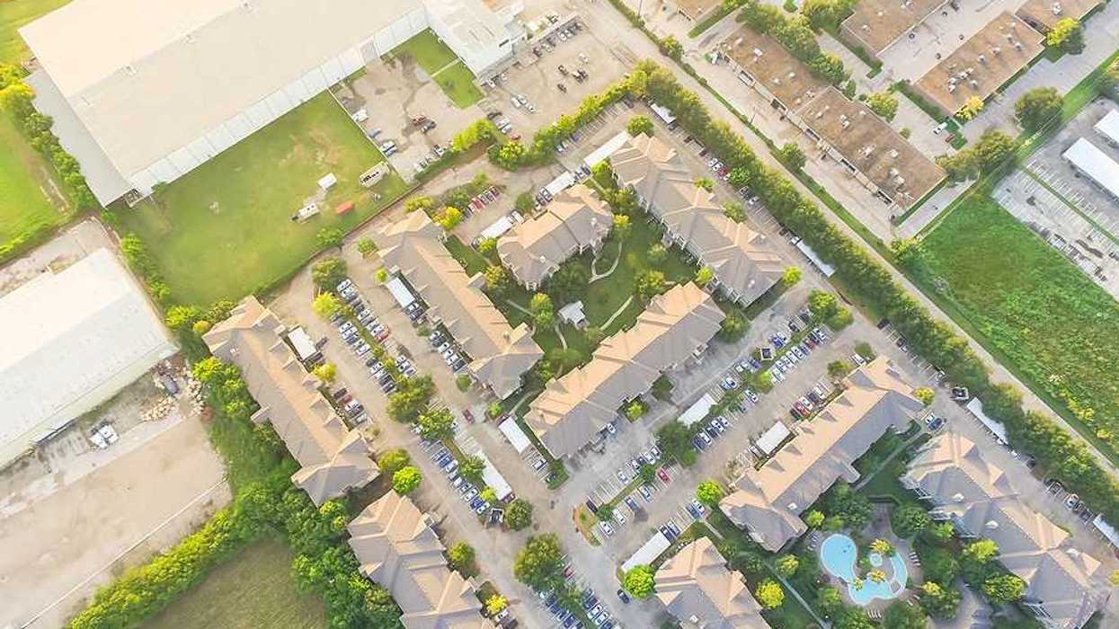 An aerial view of a warehouse sited next to apartment buildings