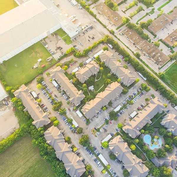 An aerial view of a warehouse sited next to apartment buildings