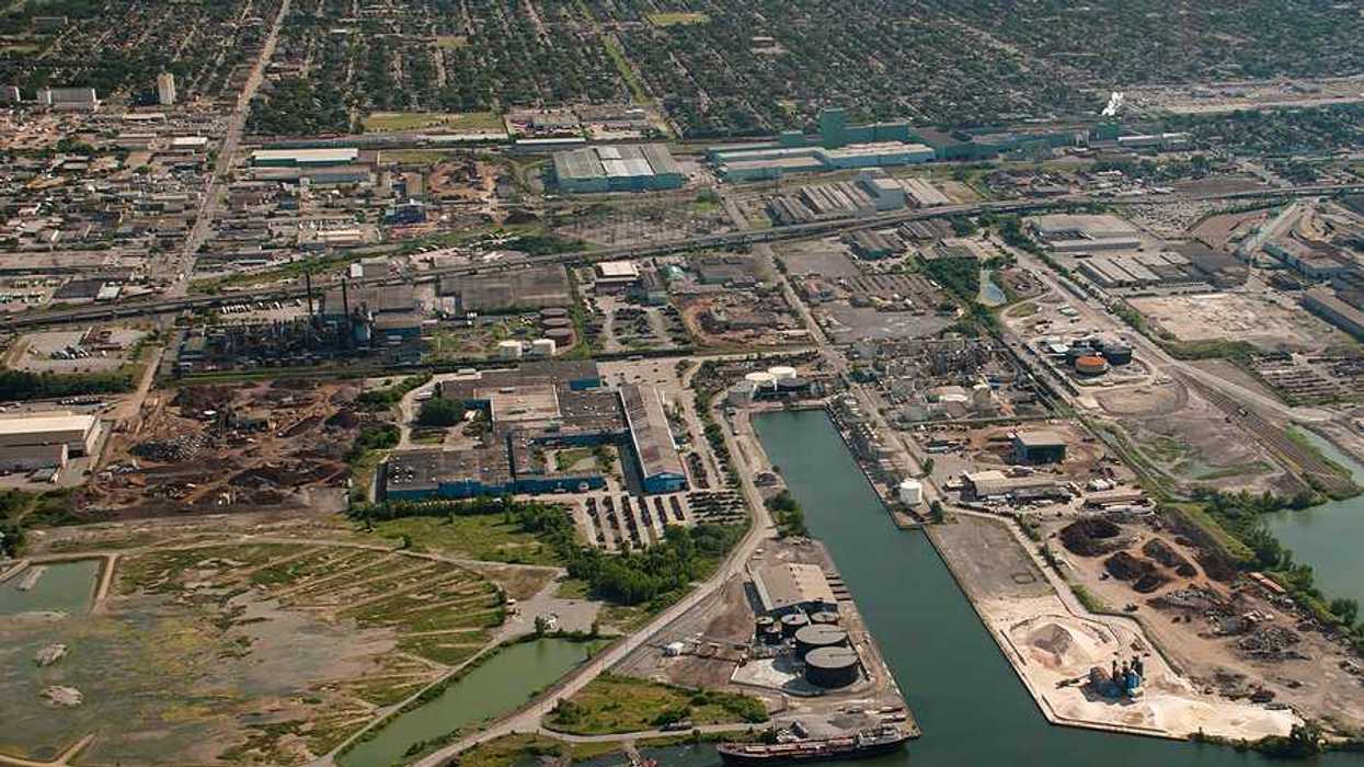 An aerial view of an industrial area along a harbor