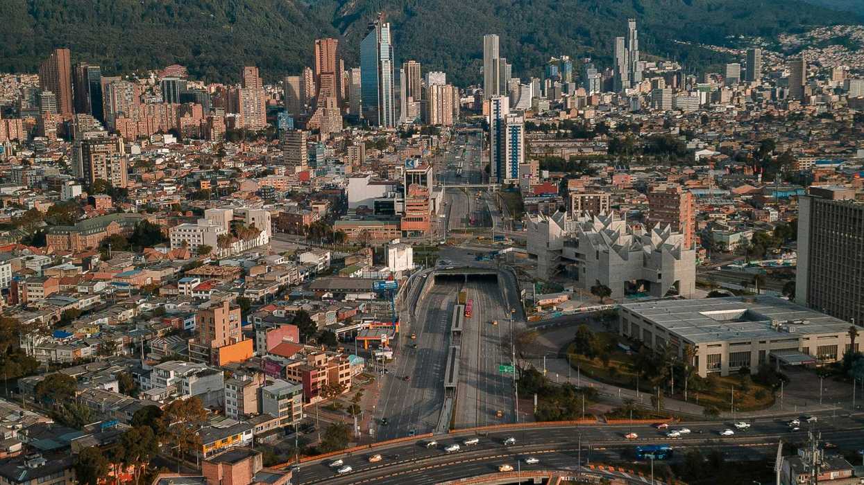 An aerial view of Bogotá, Colombia, with mountains in the background.