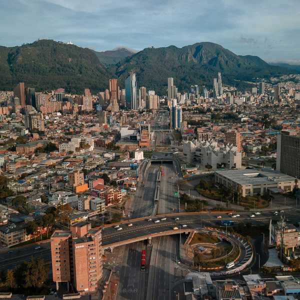 An aerial view of Bogotá, Colombia, with mountains in the background.