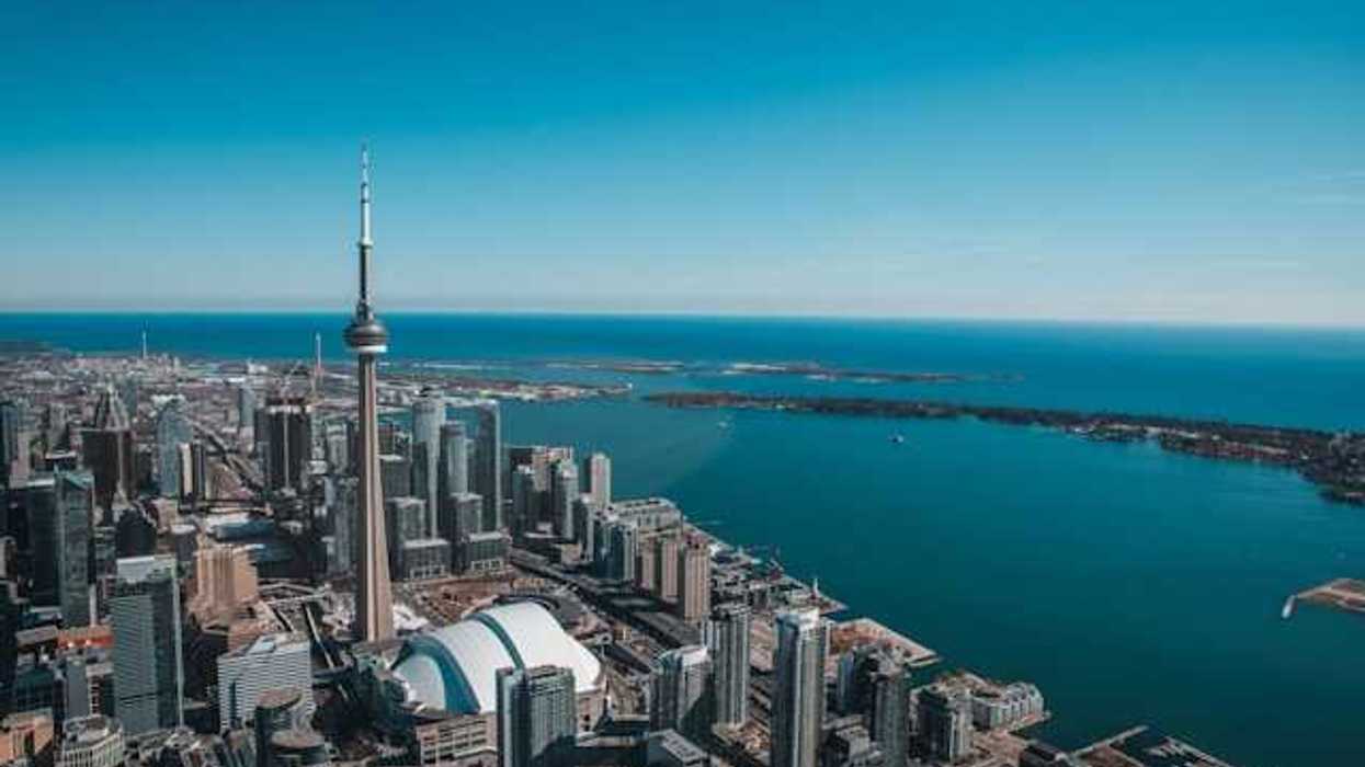 An aerial view of the city of Toronto with Lake Ontario in the background