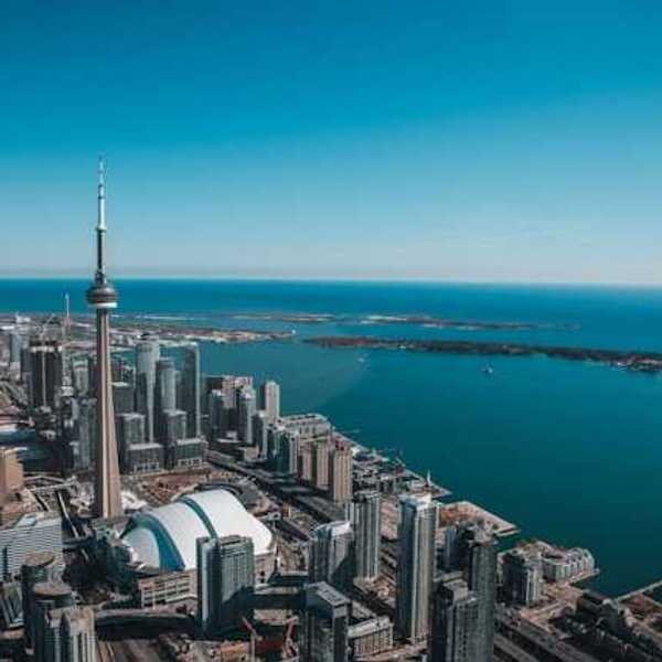 An aerial view of the city of Toronto with Lake Ontario in the background