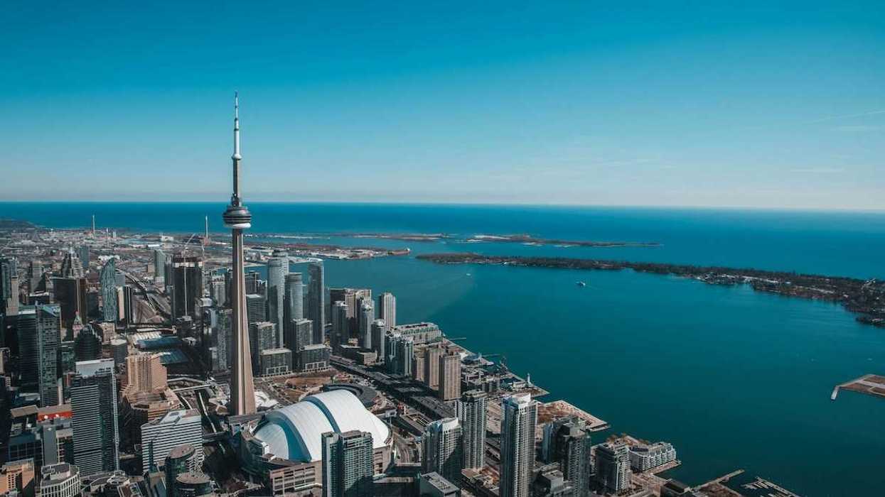 An aerial view of the city of Toronto with Lake Ontario in the background