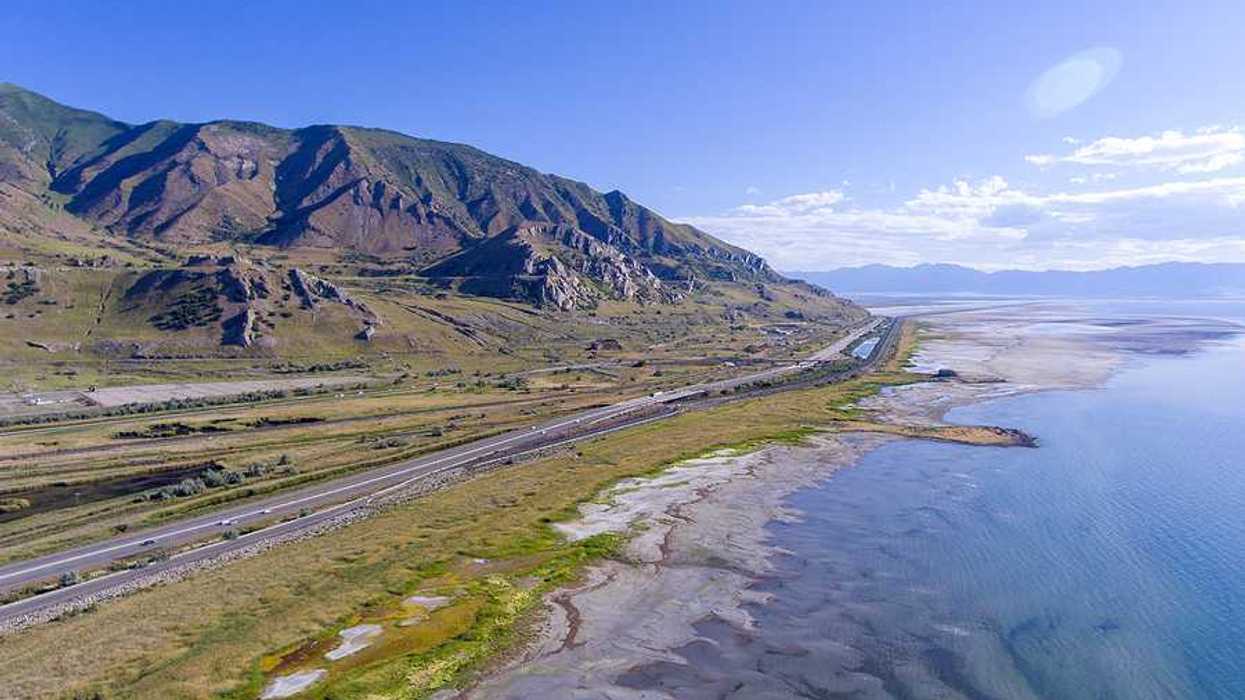 An aerial view of the Great Salt Lake and Highway 80 running alongside the shore