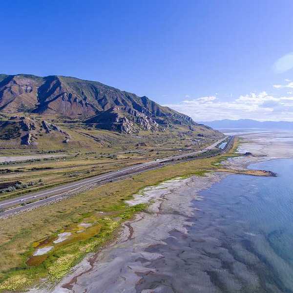 An aerial view of the Great Salt Lake and Highway 80 running alongside the shore