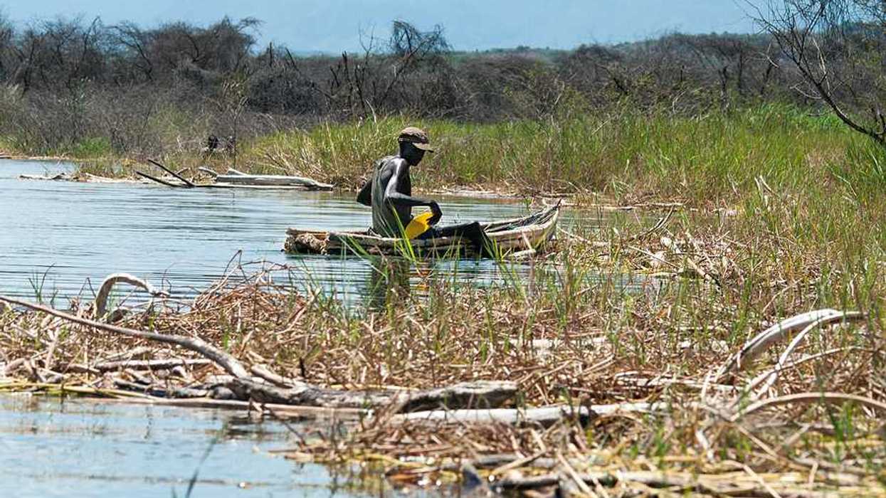 An African man in a small fishing boat