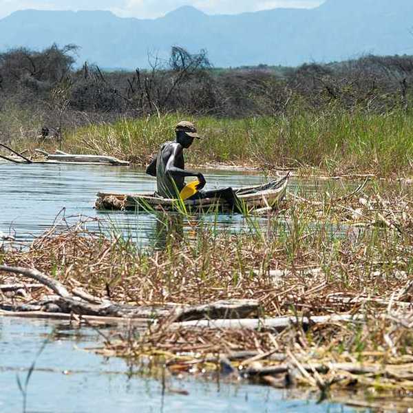 An African man in a small fishing boat