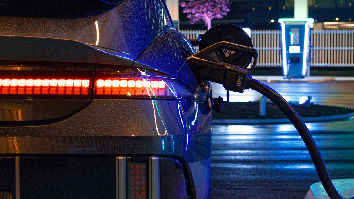an electric car plugged in to a charging station.