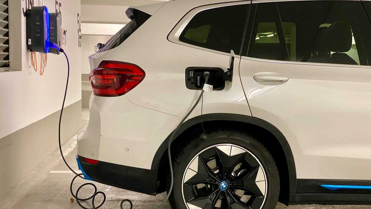 an electric car plugged in to a charging station.