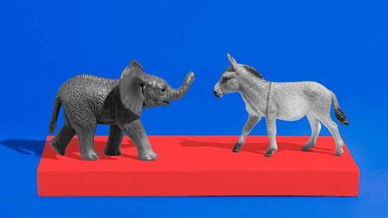 An elephant and a donkey figurine on a red platform with a blue background
