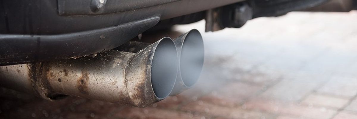An exhaust pipe with smoke emitting from it.