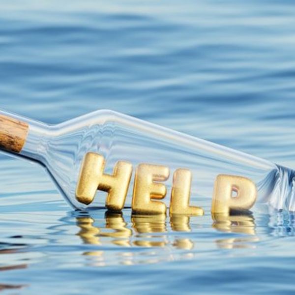 An illustration of a glass bottle floating in water with the word HELP inside of it.