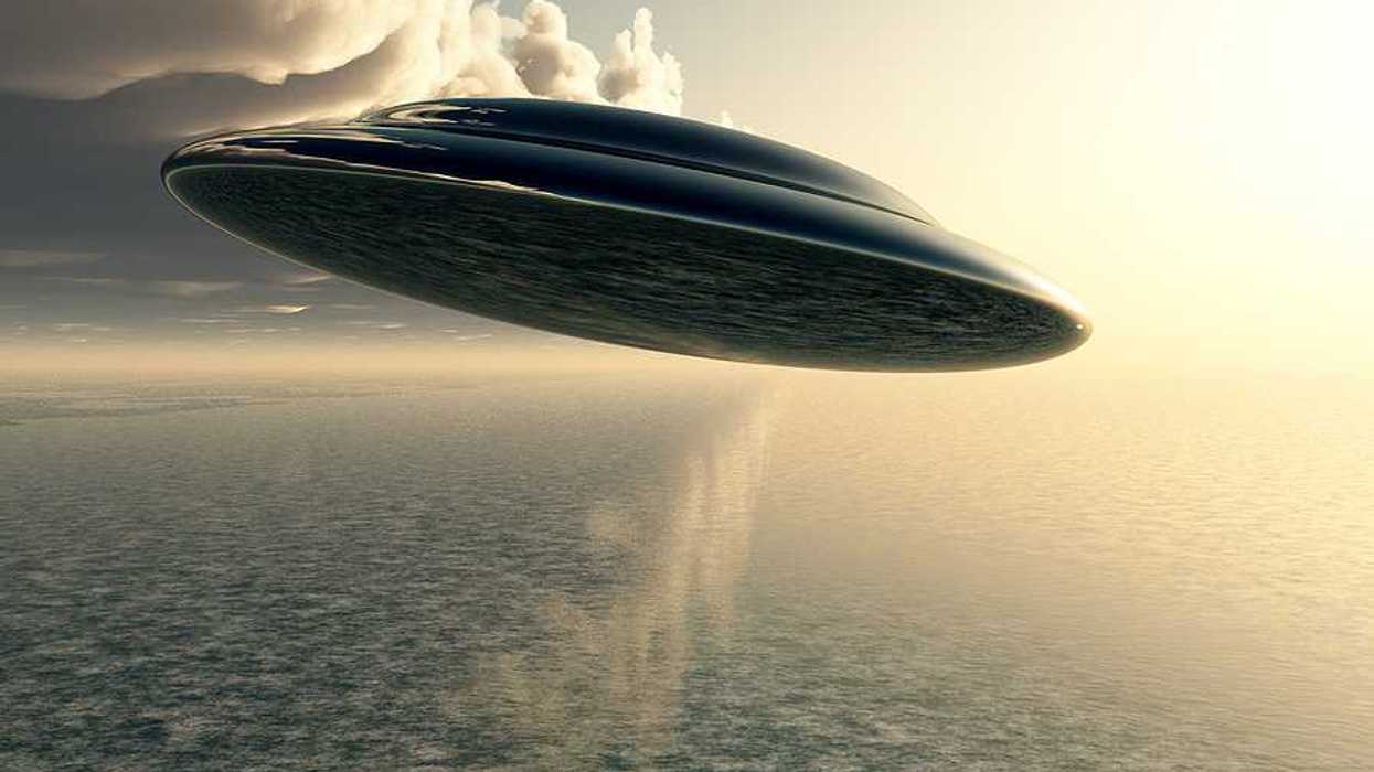 An illustration of a saucer-like space ship flying against a cloudy sky