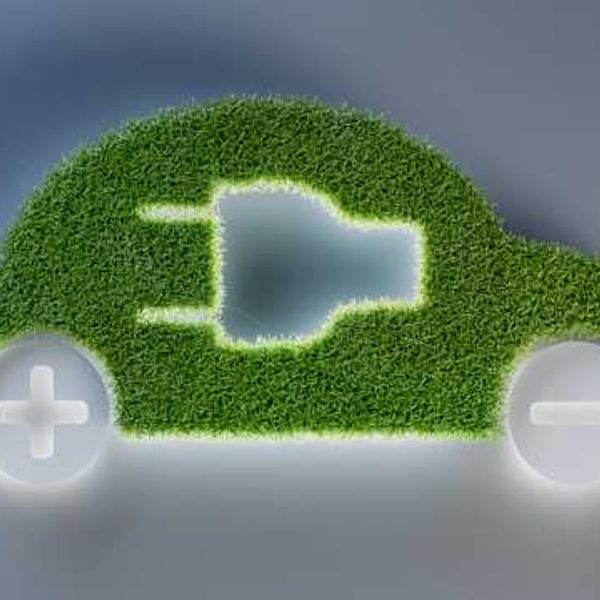An illustration of an electric vehicle with green grass for the body of the car