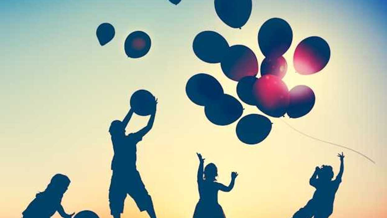 An illustration of children in silhouette releasing balloons into the sky