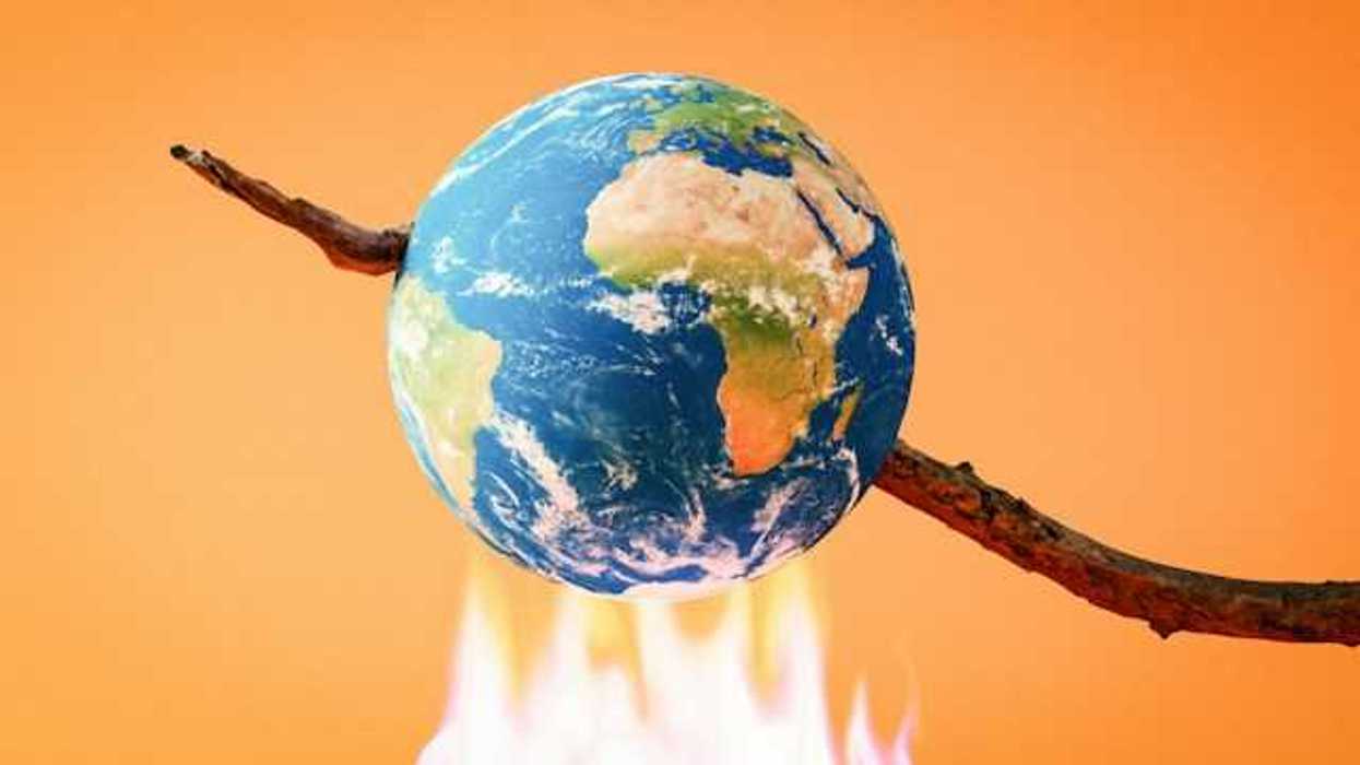 An illustration of the earth on a stick being burned over a fire