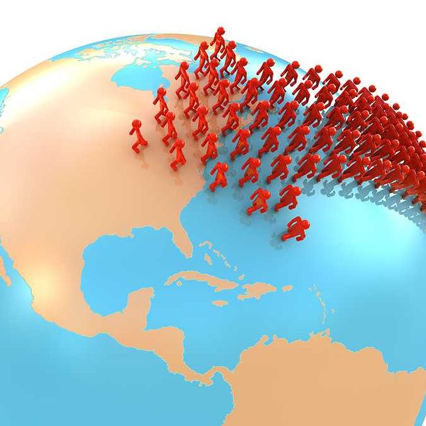 An illustration of the globe with people migrating toward the U.S.