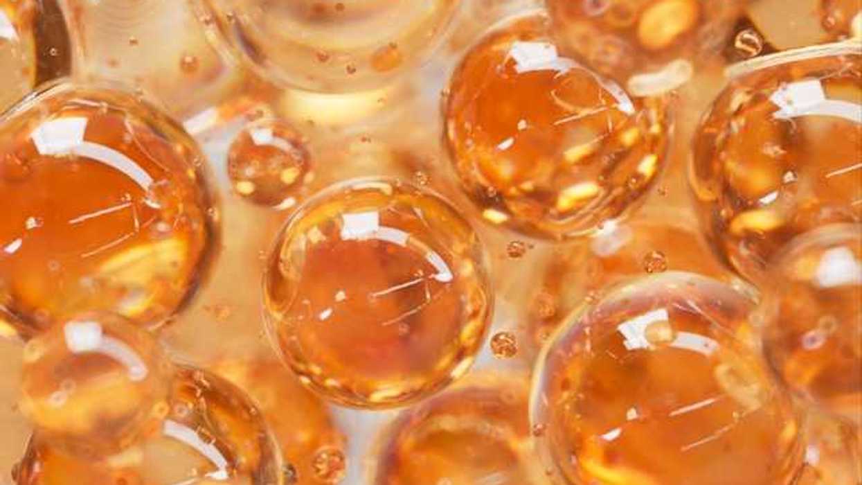 An illustration with orange colored liquid balls that look like bubbles