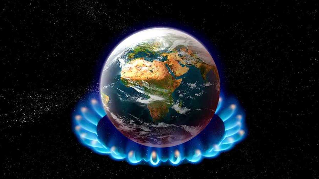 An image of the earth sitting on top of a gas stove burner